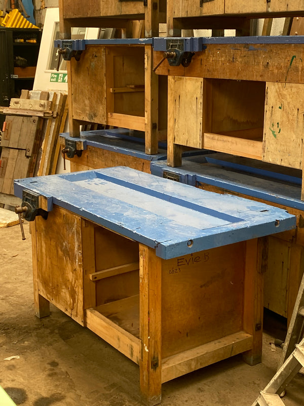 Reclaimed wooden work benches with vices