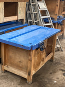 Reclaimed wooden work benches with vices