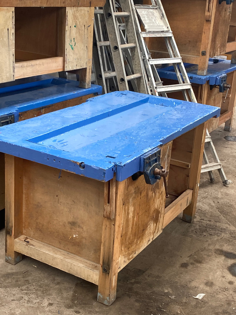 Reclaimed wooden work benches with vices